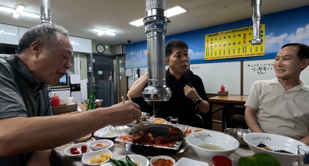 불판 앞에서 저녁을 먹는 친구들